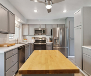 The kitchen features sleek GE Profile appliances, pull-out cabinet organizers, and custom countertops. There's also abundant cabinetry and counter space.